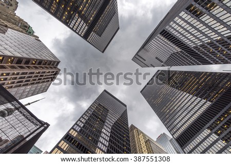 A low angle view of skyscrapers on an grey overcast day.