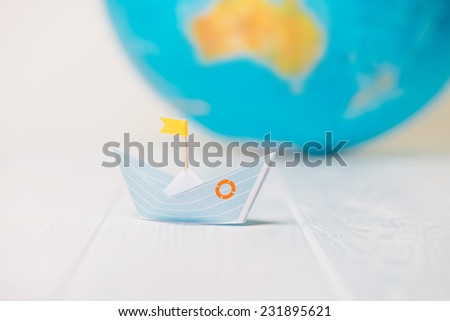 Origami boat, paper boat with a globe