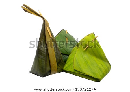 Thai dessert sticky rice wrapped in banana leaf isolated on white background
