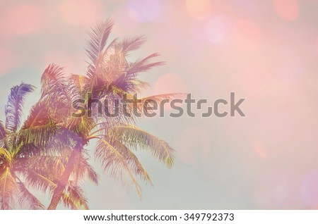 Tropical palm tree double expose with colorful bokeh light abstract background.Retro color style.