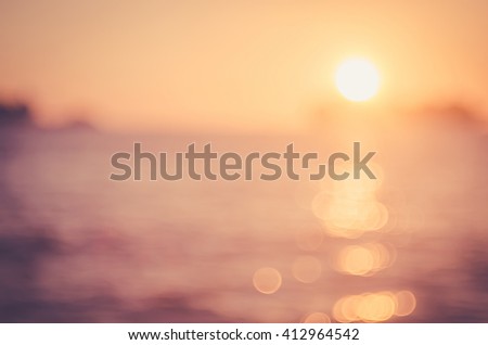 Blur sunset beach with bokeh sun light wave abstract background. Travel concept. Retro color style.
