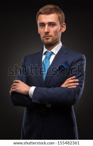 portrait of handsome businessman on black