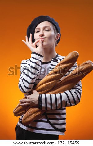 woman holding baguettes and shows that taste is delicious