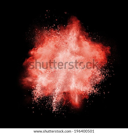 Red powder explosion isolated on black background