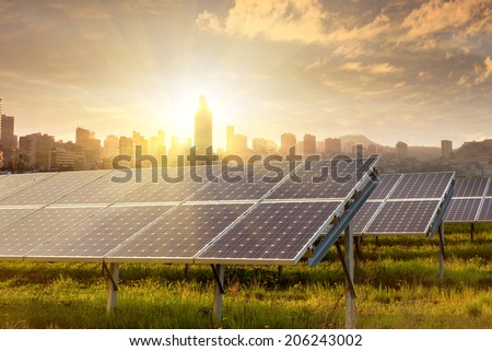 solar panels against city view on sunset