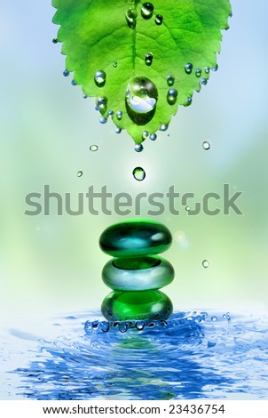 balancing spa shiny stones in water splash with leaf and drops