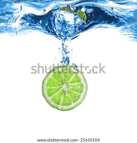 Fresh lime dropped into water with bubbles isolated on white