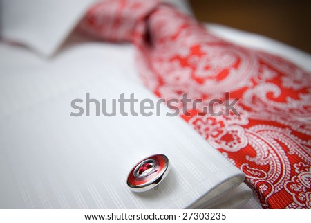 close-up photo of stud on white shirt with red tie