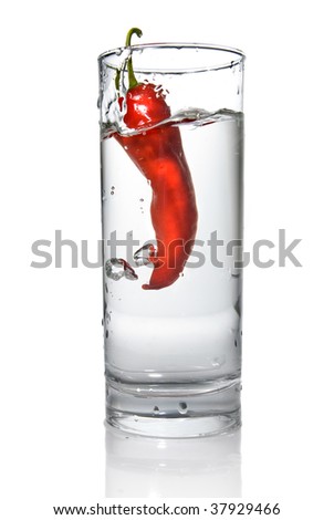red pepper dropped into water glass with bubbles