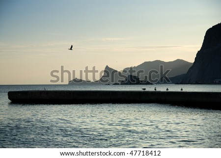 landscape with sea and mountains on sunset