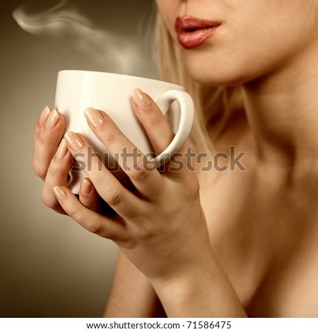 stock%20photo%20:%20woman%20holding%20hot%20cup%20and%20blowing%20on%20it