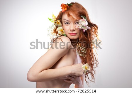 Portrait of beautiful naked woman with spring flowers