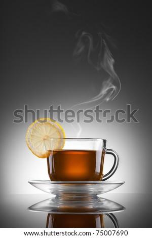 cup of hot tea with lemon and steam