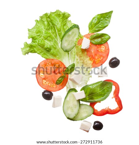 salad isolated in white - red tomatoes, pepper, cheese, basil, cucumber and olives, top view