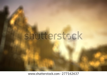 Defocused view of european city center houses against beautiful sunset, evening. Background with natural bokeh.