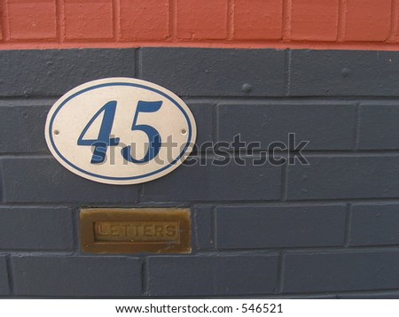 colourful wall with house number and letter box.