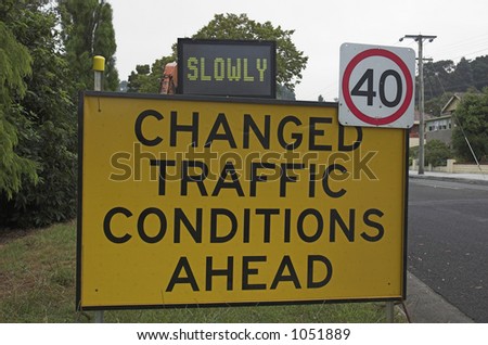 Temporary warning sign advising drivers to go slowly due to changed traffic conditions.