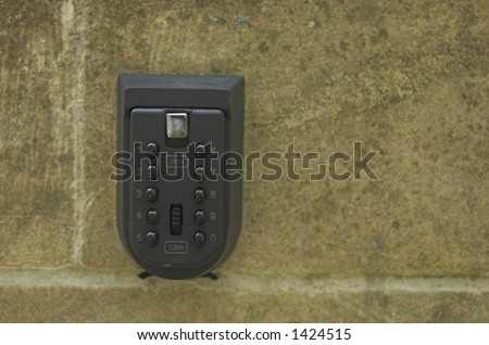 Mini \'key lock\' safe on exterior wall of building.