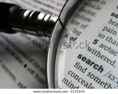 stock photo : Magnifying glass on dictionary page with the word 'search'.