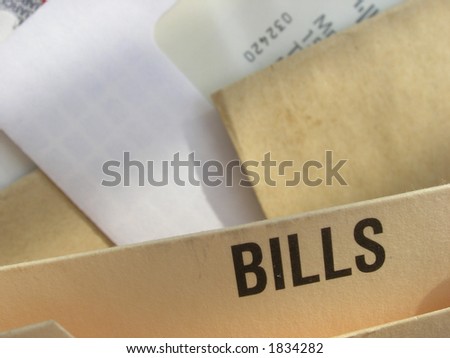 Filing system full of bills to pay. Concept of cost of living, financial pressures, debt.