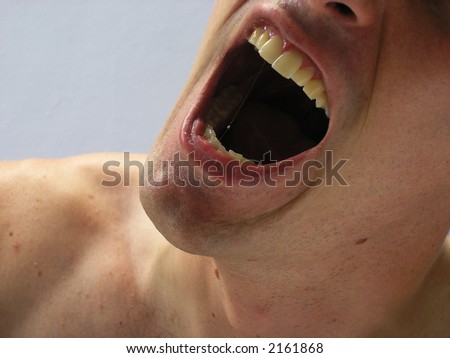 Man with mouth wide open shouting.