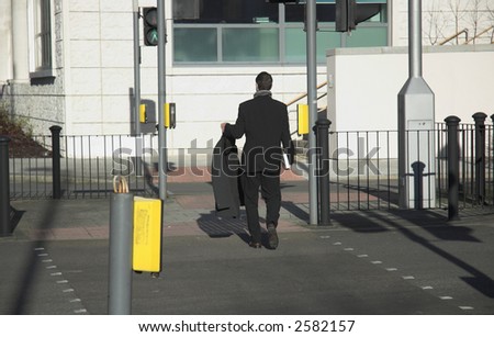 Young business man on the way to work with a spare suit.