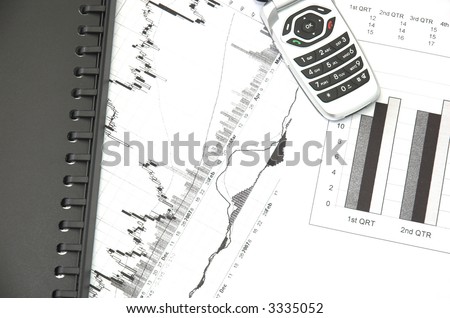 Business still life with charts showing performance over quarterly financial periods and stock prices.