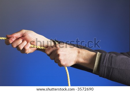 Concept image of hands pulling on a rope, illustrating competition, challenge, effort etc.