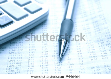 Stock price data in the newspaper with pen and calculator.