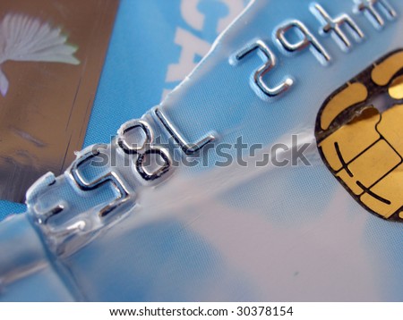 Close up on pieces of torn up credit card.
