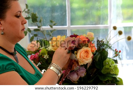 People finishing beautiful and rich bouquet on the competition for florists in Sofia, Bulgaria Aprl 30, 2013