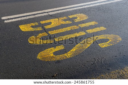 Bus sign with yellow paint on asphalt