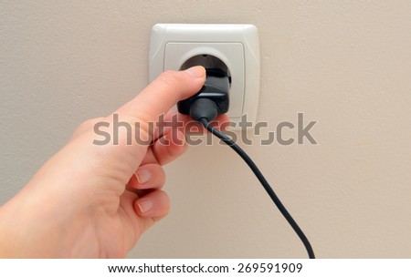 Women hand connect electricity plug