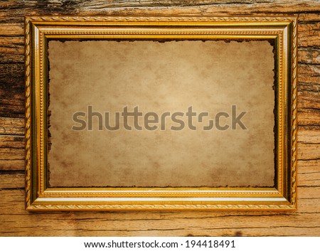 Old Paper in picture frame wiht wooden background
