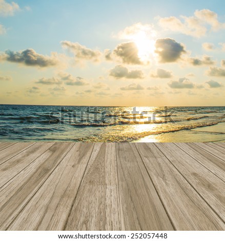 Empty wooden deck floor over sea and sunset background