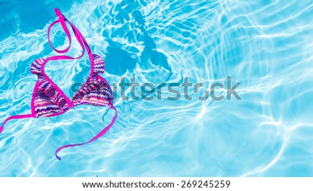 Kid bikini in clean water. Swim suit floating in a swimming pool.