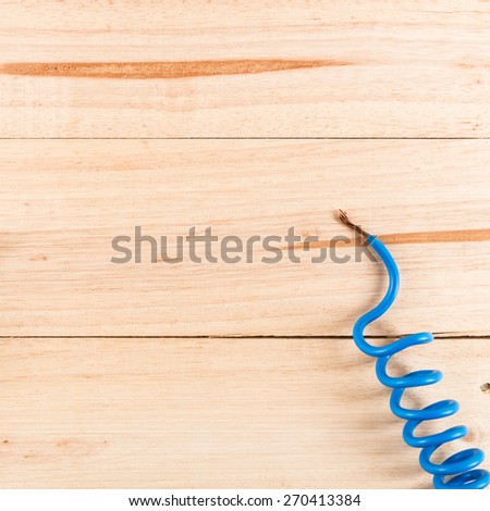 Electric cable ends on wooden table.