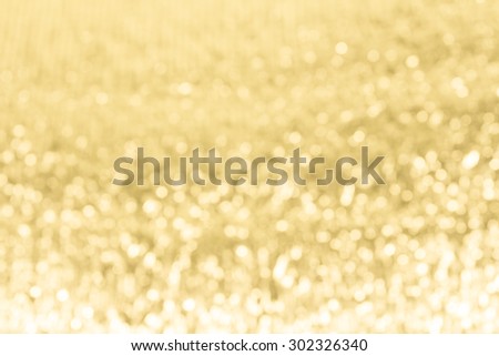 Gold festive glitter background with defocused lights