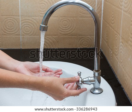 Hand opened the tap water,Cleaning Hands. Washing hands.