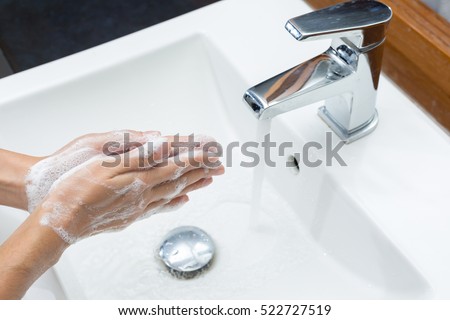 Woman in a bathrobe is washing hands,Hygiene. Cleaning Hands.