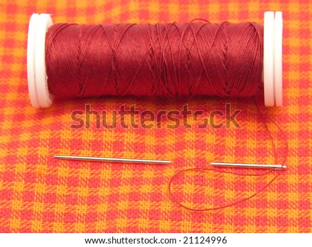 Checked cloth with needle and thread
