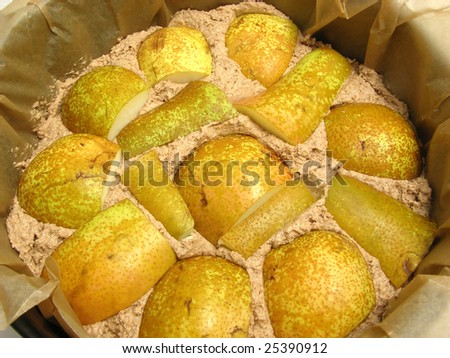 Dough of a wholemeal cake with pears in a baking pan