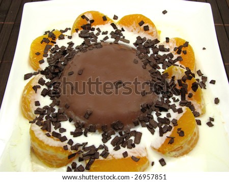Chocolate pudding with yogurt, sliced tangerines and chocolate granules