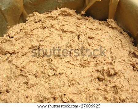 Mixed unbaken chocolate dough in a baking pan with baking paper