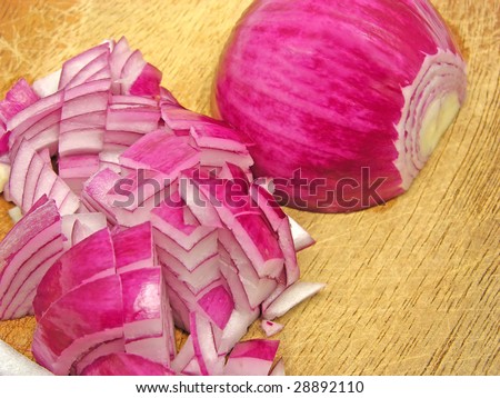 Diced red onion on a brown wooden plate