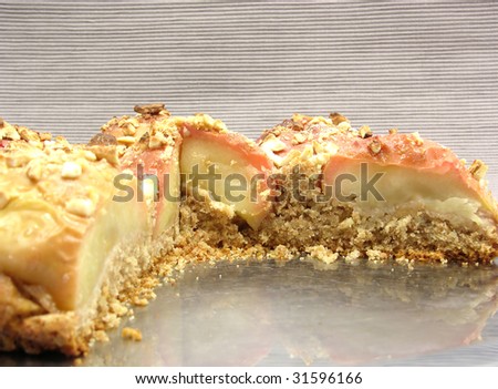 Cutted  wholemeal apple cake on a cake tray on gray background