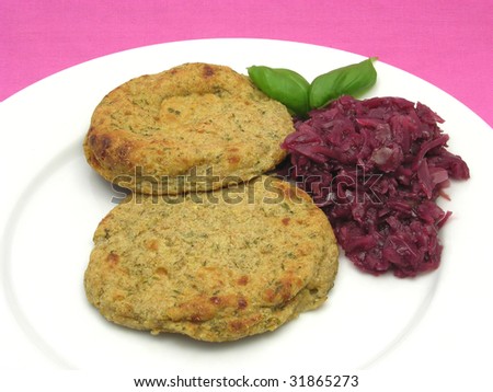 Round flat potato dough cakes with basil and red cabbage