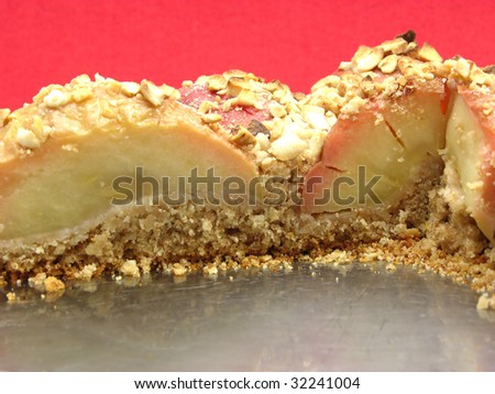 wholemeal apple cake  on a cake tray on red background