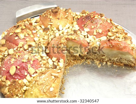 Cutted  wholemeal apple cake on a cake tray on gray background