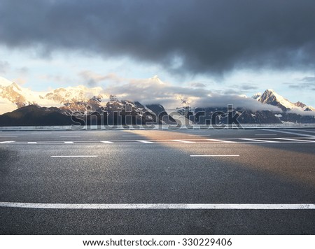 beautiful asphalt road in snow mountain area